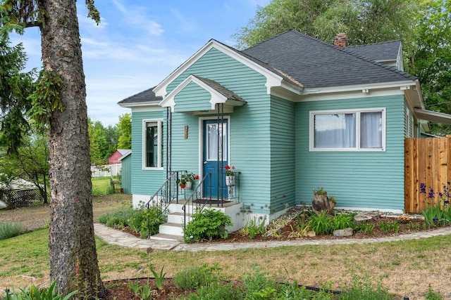 697 N Hofstetter St, Colville, WA 99114 - bungalow featuring a shingled roof and a chimney