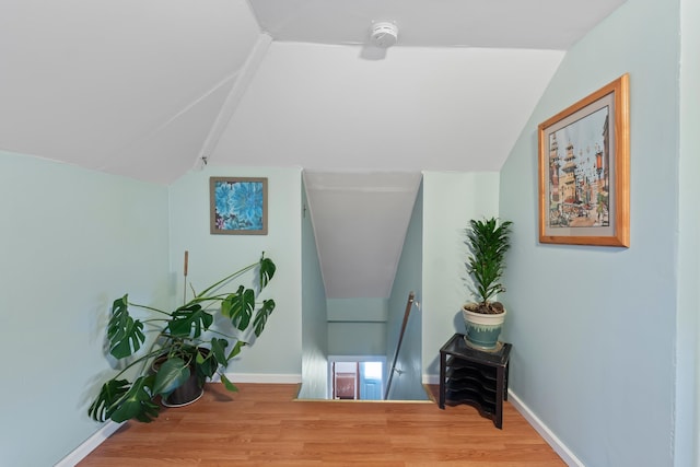 697 N Hofstetter St, Colville, WA 99114 - corridor with an upstairs landing, vaulted ceiling, wood finished floors, and baseboards