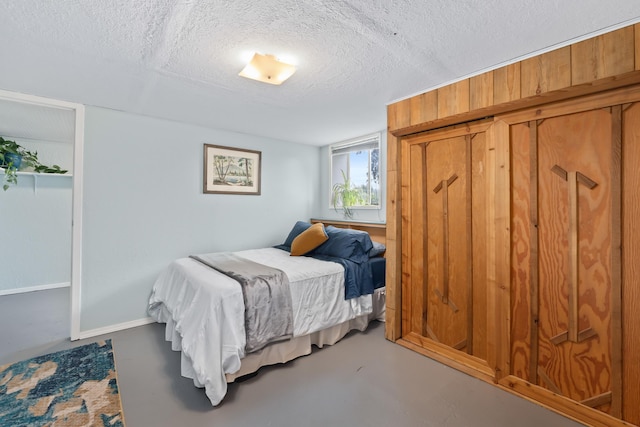 697 N Hofstetter St, Colville, WA 99114 - bedroom with a textured ceiling, a closet, and finished concrete flooring