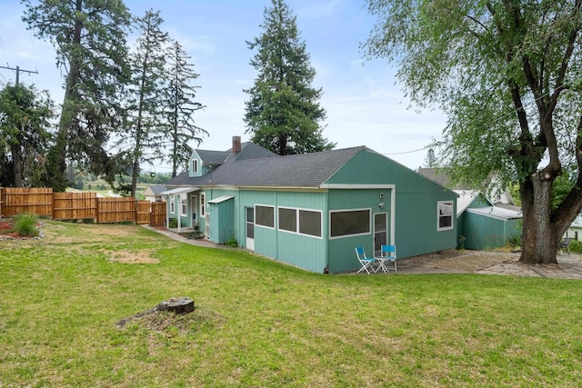 697 N Hofstetter St, Colville, WA 99114 - back of house with a shingled roof and a chimney