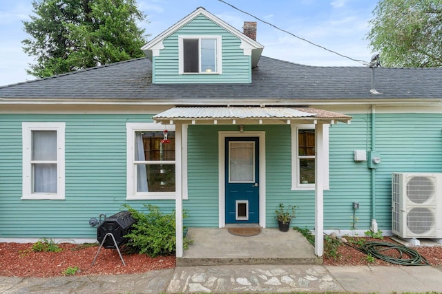 697 N Hofstetter St, Colville, WA 99114 - view of front of house featuring a chimney, ac unit, a shingled roof, and a porch