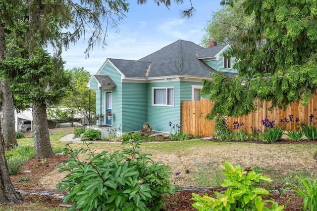 697 N Hofstetter St, Colville, WA 99114 - view of front of home featuring roof with shingles and a chimney
