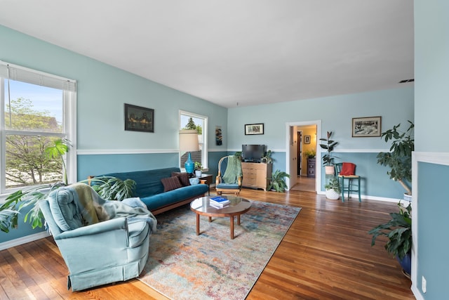697 N Hofstetter St, Colville, WA 99114 - living room featuring healthy amount of natural light, wood finished floors, and baseboards