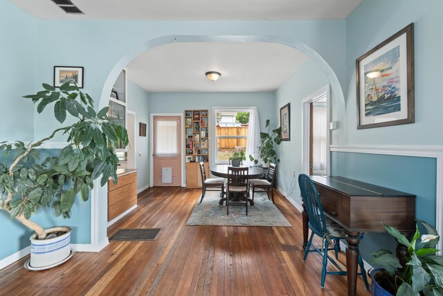697 N Hofstetter St, Colville, WA 99114 - dining space with arched walkways, dark wood finished floors, and baseboards