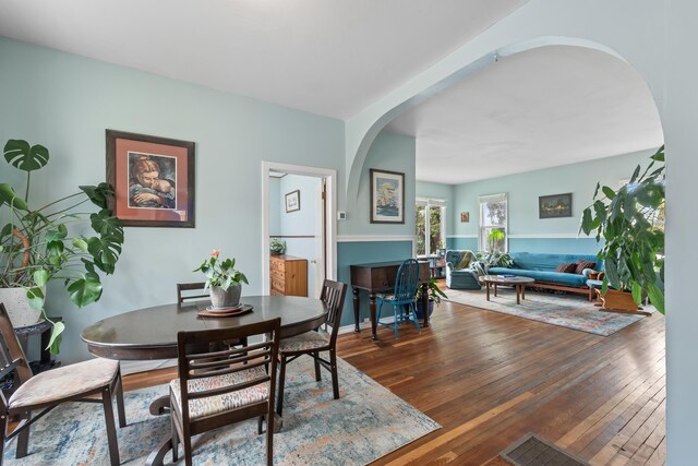 697 N Hofstetter St, Colville, WA 99114 - dining area with arched walkways and hardwood / wood-style flooring