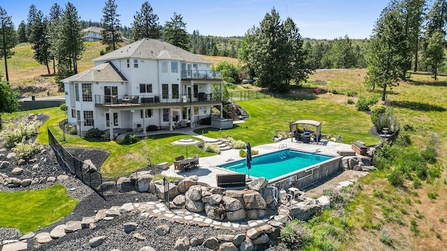 10409 E Grouse Mountain Ln, Spokane, WA 99206 - back of house with a patio, a wooden deck, stairs, an outdoor pool, and a fire pit