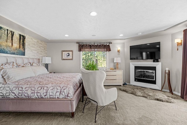 10409 E Grouse Mountain Ln, Spokane, WA 99206 - bedroom featuring carpet floors, a textured ceiling, a glass covered fireplace, recessed lighting, and baseboards