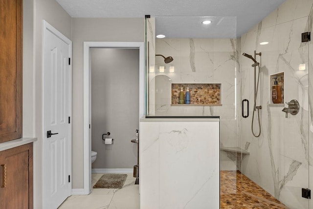 10409 E Grouse Mountain Ln, Spokane, WA 99206 - bathroom with a marble finish shower, toilet, and baseboards