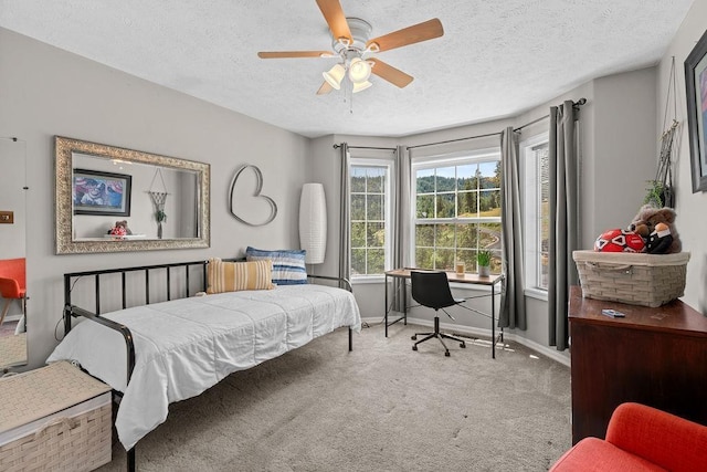 10409 E Grouse Mountain Ln, Spokane, WA 99206 - bedroom featuring carpet, baseboards, a textured ceiling, an office area, and a ceiling fan