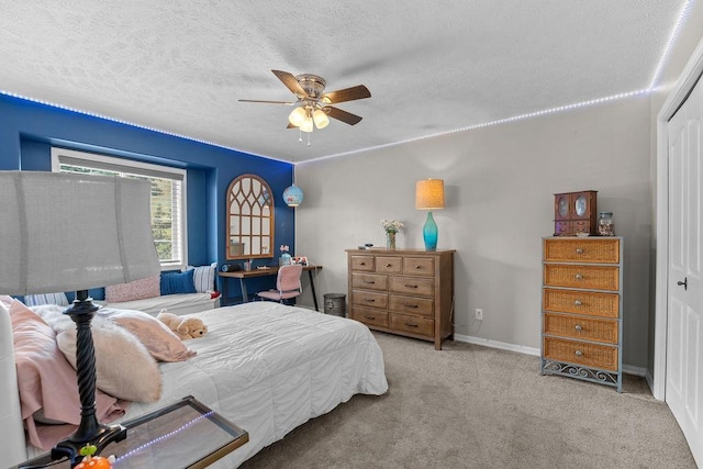 10409 E Grouse Mountain Ln, Spokane, WA 99206 - carpeted bedroom with a textured ceiling, ceiling fan, baseboards, and a closet