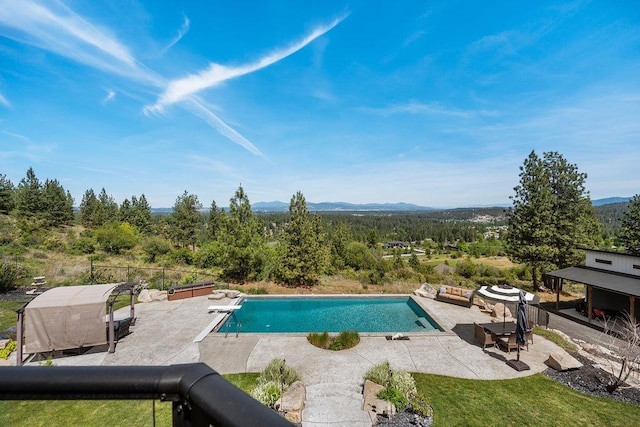 10409 E Grouse Mountain Ln, Spokane, WA 99206 - outdoor pool featuring a patio area, a diving board, and a mountain view