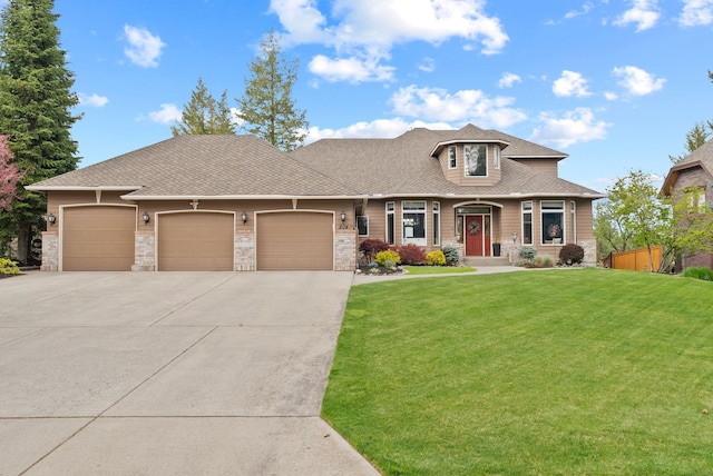 504 W Wilson Ct, Spokane, WA 99208 - view of front of home featuring an attached garage, concrete driveway, stone siding, and a shingled roof
