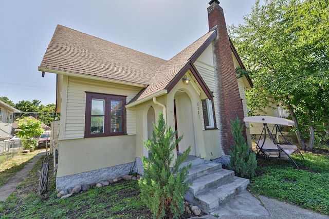 2321 W Boone Ave, Spokane, WA 99201 - english style home featuring a chimney, stucco siding, and a shingled roof