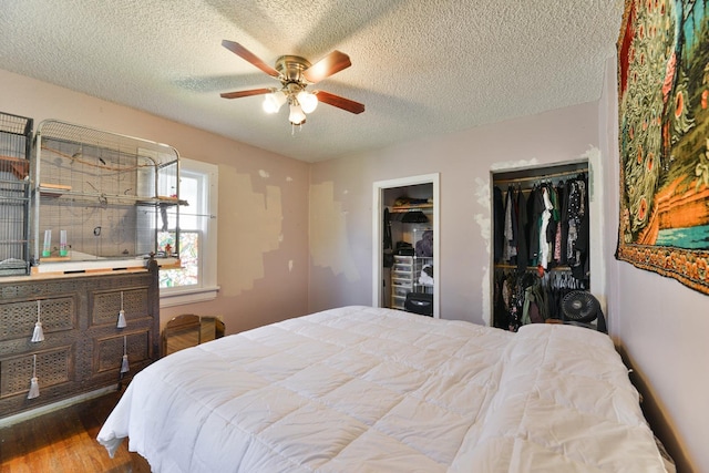 2321 W Boone Ave, Spokane, WA 99201 - bedroom with wood finished floors, a textured ceiling, ceiling fan, and multiple closets
