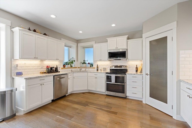 17323 N Lower Greenbluff Rd, Colbert, WA 99005 - kitchen featuring stainless steel appliances, white cabinets, tasteful backsplash, and recessed lighting