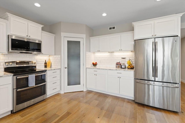 17323 N Lower Greenbluff Rd, Colbert, WA 99005 - kitchen with stainless steel appliances, light wood finished floors, white cabinetry, backsplash, and recessed lighting