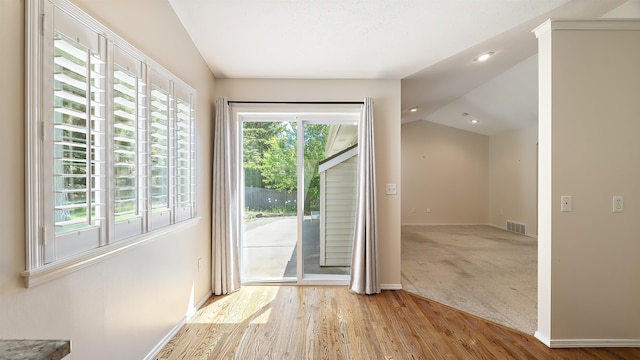 3404 W Excell Ave, Spokane, WA 99208 - doorway to outside featuring vaulted ceiling, wood finished floors, baseboards, recessed lighting, and carpet flooring