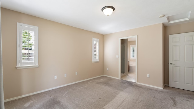 3404 W Excell Ave, Spokane, WA 99208 - unfurnished bedroom with carpet, baseboards, connected bathroom, and attic access