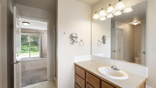 3404 W Excell Ave, Spokane, WA 99208 - bathroom with vanity, toilet, tile patterned flooring, and baseboards