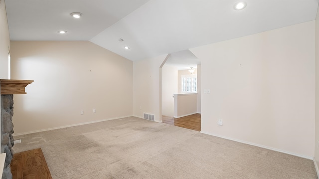 3404 W Excell Ave, Spokane, WA 99208 - unfurnished living room featuring carpet, a stone fireplace, recessed lighting, baseboards, and lofted ceiling
