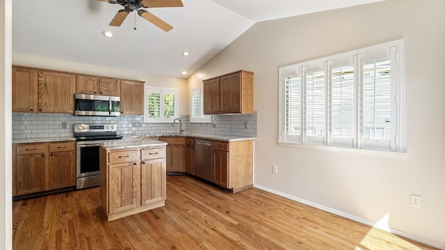 3404 W Excell Ave, Spokane, WA 99208 - kitchen with appliances with stainless steel finishes, lofted ceiling, decorative backsplash, a ceiling fan, and wood finished floors