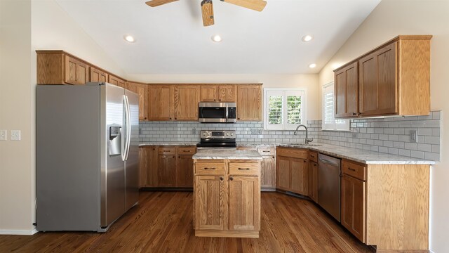 3404 W Excell Ave, Spokane, WA 99208 - kitchen with appliances with stainless steel finishes, vaulted ceiling, a sink, a kitchen island, and dark wood finished floors