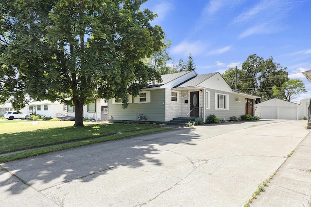 5607 N Elgin St, Spokane, WA 99205 - view of front facade featuring a detached garage, an outdoor structure, a front lawn, and stone siding