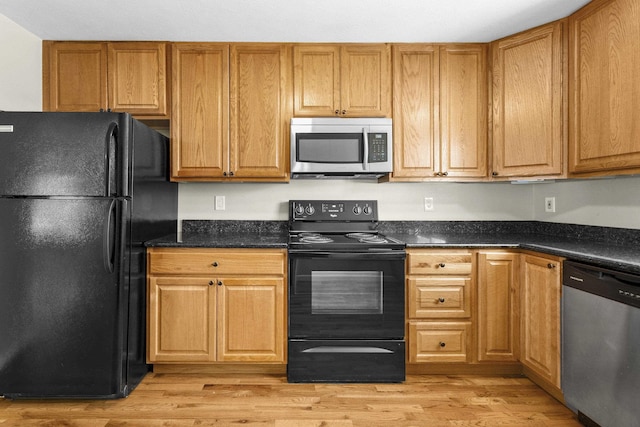 5607 N Elgin St, Spokane, WA 99205 - kitchen featuring black appliances, light wood-style flooring, and brown cabinetry