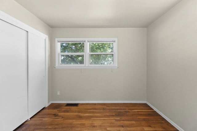 5607 N Elgin St, Spokane, WA 99205 - unfurnished bedroom featuring wood finished floors, a closet, and baseboards