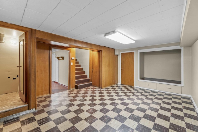 5607 N Elgin St, Spokane, WA 99205 - finished basement with tile patterned floors, wooden walls, and stairway