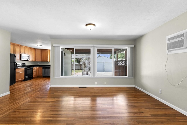 5607 N Elgin St, Spokane, WA 99205 - unfurnished living room featuring dark wood-style flooring, baseboards, and an AC wall unit