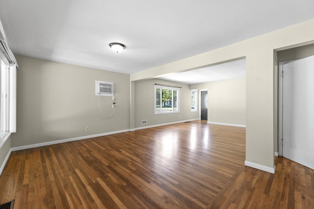 5607 N Elgin St, Spokane, WA 99205 - unfurnished room featuring wood finished floors, baseboards, and a wall unit AC