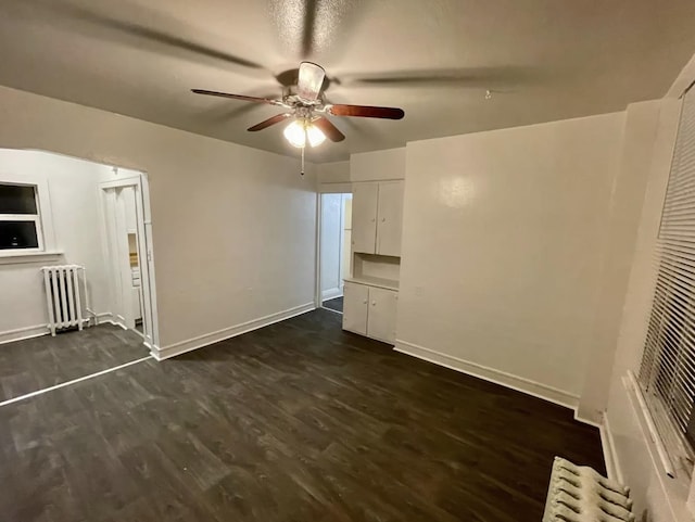 1101 W Maxwell Ave, Spokane, WA 99201 - unfurnished living room with radiator heating unit, a ceiling fan, dark wood-style floors, and baseboards
