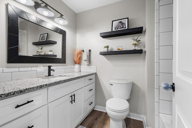 12327 E Sioux Cir, Spokane Valley, WA 99206 - full bathroom featuring vanity, wood finished floors, toilet, and baseboards