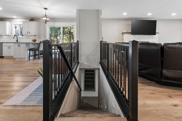 12327 E Sioux Cir, Spokane Valley, WA 99206 - stairs with recessed lighting, wood finished floors, and a chandelier