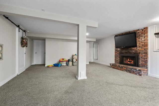 12327 E Sioux Cir, Spokane Valley, WA 99206 - finished below grade area with carpet flooring, a brick fireplace, baseboards, and a barn door