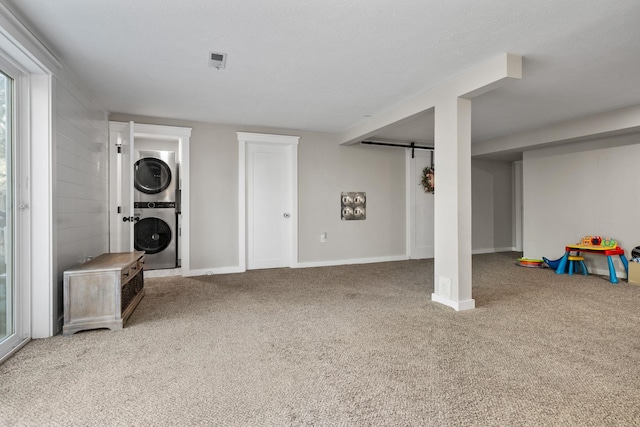 12327 E Sioux Cir, Spokane Valley, WA 99206 - basement featuring stacked washer / drying machine, carpet floors, a barn door, and baseboards