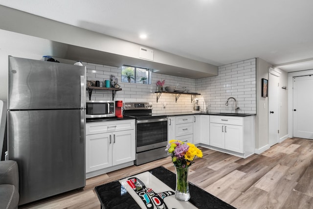 12327 E Sioux Cir, Spokane Valley, WA 99206 - kitchen with stainless steel appliances, open shelves, a sink, dark countertops, and tasteful backsplash
