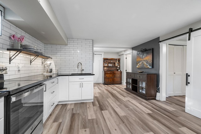 12327 E Sioux Cir, Spokane Valley, WA 99206 - kitchen featuring stainless steel electric range oven, a sink, open shelves, a barn door, and dark countertops