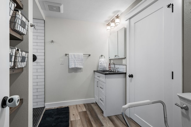 12327 E Sioux Cir, Spokane Valley, WA 99206 - full bath with tiled shower, wood finished floors, vanity, and baseboards