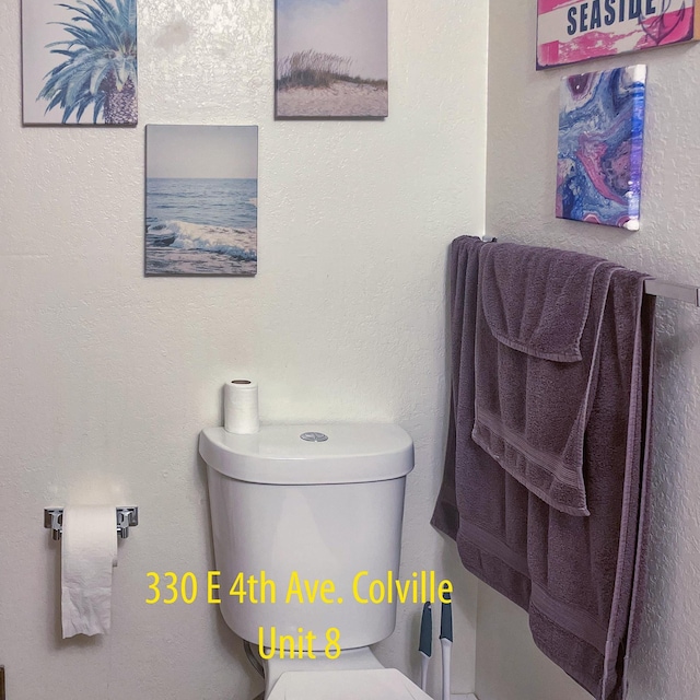 330 E 4th Ave, Colville, WA 99114 - bathroom featuring toilet and a textured wall