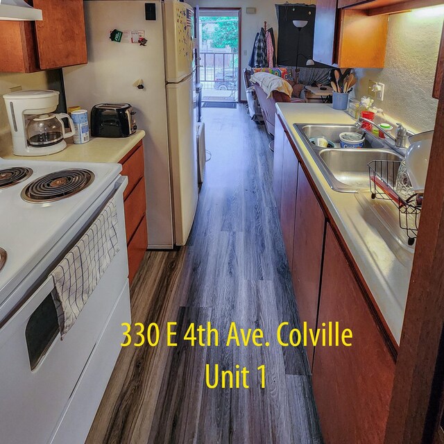 330 E 4th Ave, Colville, WA 99114 - kitchen with electric range, dark wood finished floors, a sink, light countertops, and ventilation hood