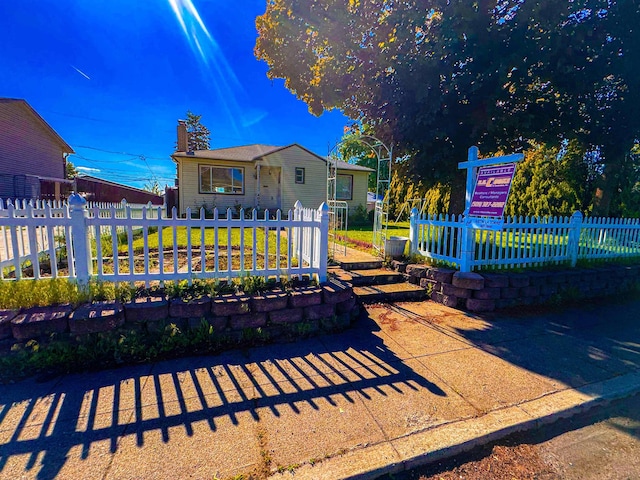 4015 N Ash St, Spokane, WA 99205 - view of front of house with a fenced front yard and a chimney