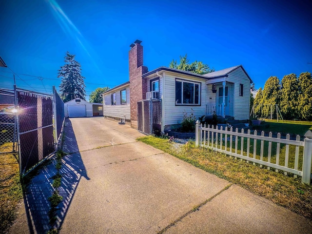 4015 N Ash St, Spokane, WA 99205 - view of front of property with a garage, a chimney, an outbuilding, and cooling unit