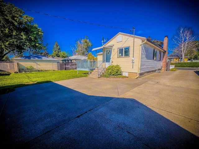 4015 N Ash St, Spokane, WA 99205 - back of house featuring a chimney and concrete driveway