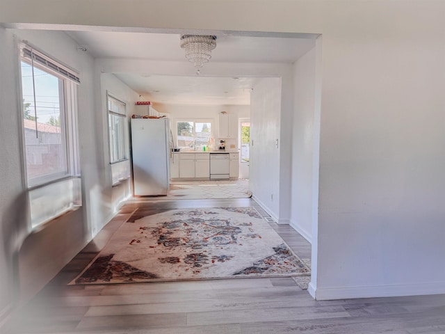 4015 N Ash St, Spokane, WA 99205 - hallway with light wood finished floors, a sink, and baseboards