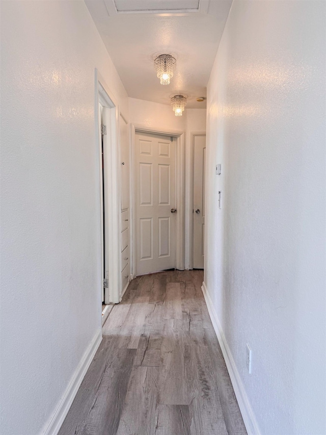 4015 N Ash St, Spokane, WA 99205 - hallway with wood finished floors, baseboards, and a chandelier