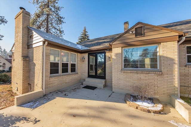 2828 S Arthur St, Spokane, WA 99203 - entrance to property with a chimney, a patio area, and brick siding
