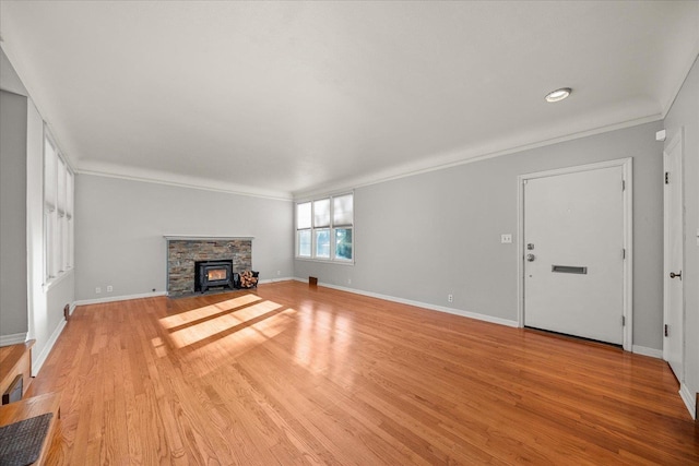 2828 S Arthur St, Spokane, WA 99203 - unfurnished living room with ornamental molding, light wood finished floors, baseboards, and a stone fireplace