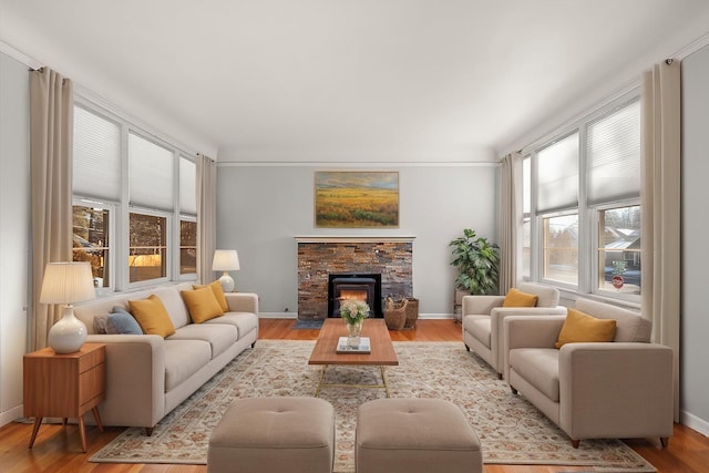 2828 S Arthur St, Spokane, WA 99203 - living area with plenty of natural light, light wood-type flooring, a stone fireplace, and baseboards